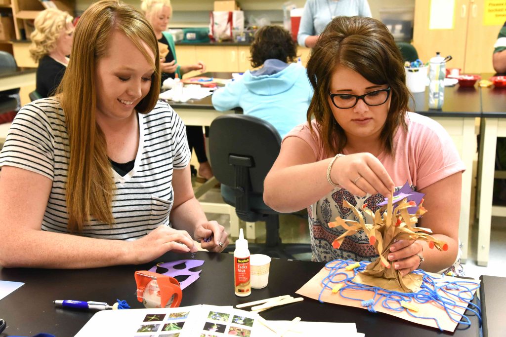 two girls with art crafts