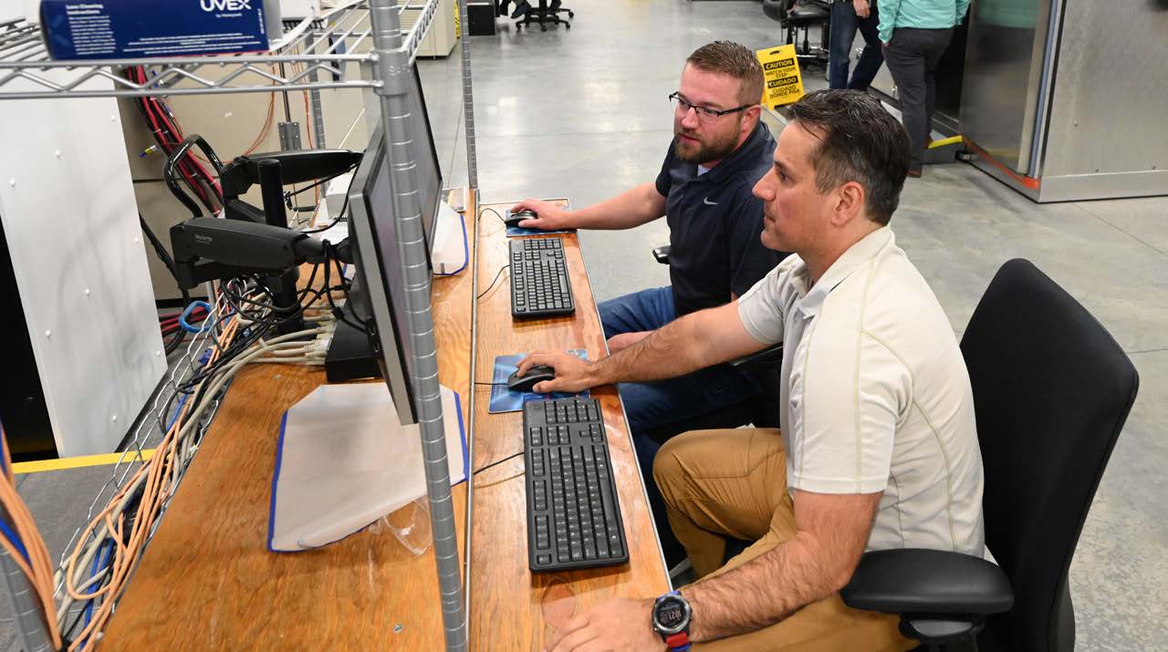 Two men at computer for machine learning
