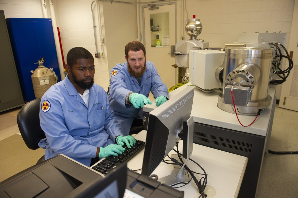 Intern and Mentor looking at computer