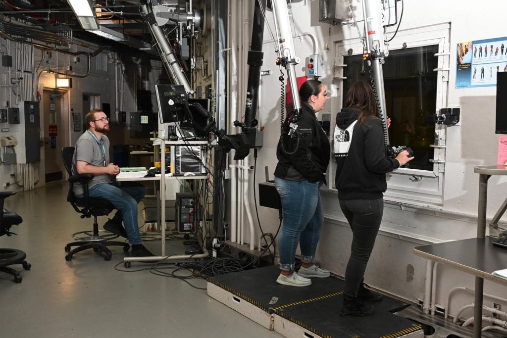 researchers working with fuel rods