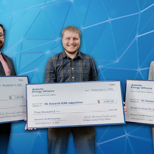 Group of people holding large checks