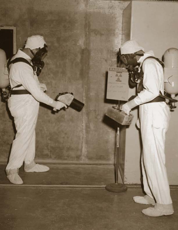 2 workers wearing anti-contamination clothing