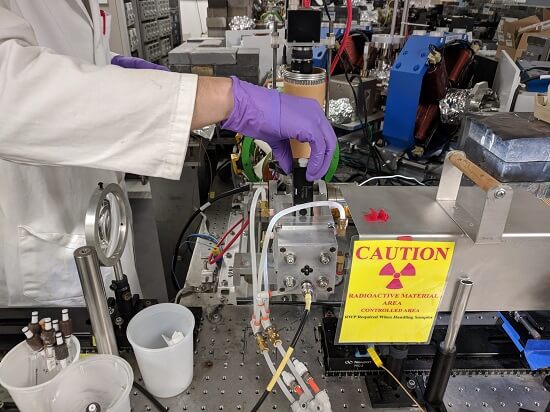 Gregory Holmbeck loading a californium-249 sample into the actinide irradiation sample holder at the Brookhaven National Laboratory Laser Electron Accelerator Facility