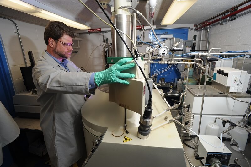 Dean Peterman operating the Materials and Fuels Complex irradiation suite solvent test loop capability.