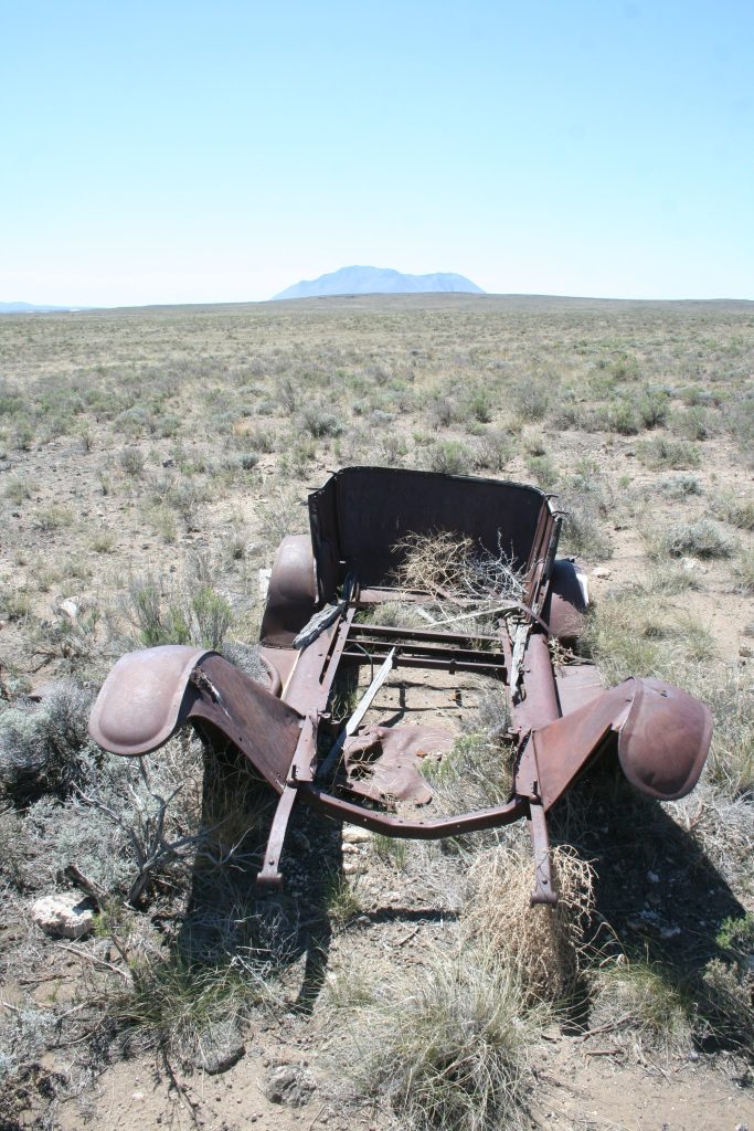 The remains of an old automobile, abandoned long ago.
