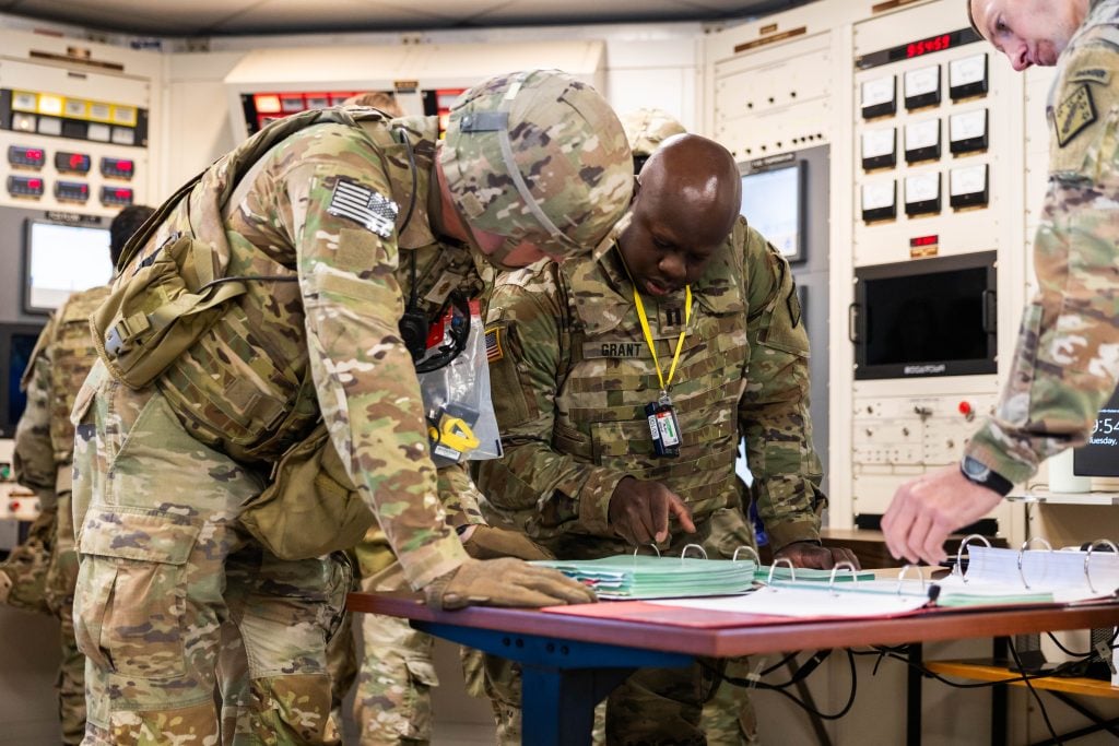 U.S. Army Nuclear Disablement Team (NDT) soldiers from the 20th Chemical, Biological, Radiological, Nuclear and Explosives (CBRNE) Command review procedures during a validation field exercise inside the control room of the Idaho National Laboratory’s Transient Reactor Test Facility (TREAT).