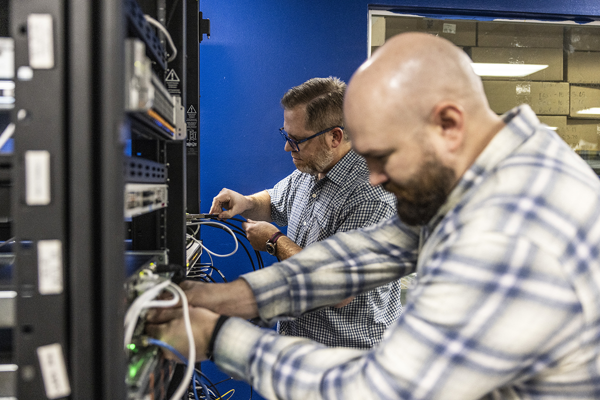 CyberSentry team members working on computer wiring