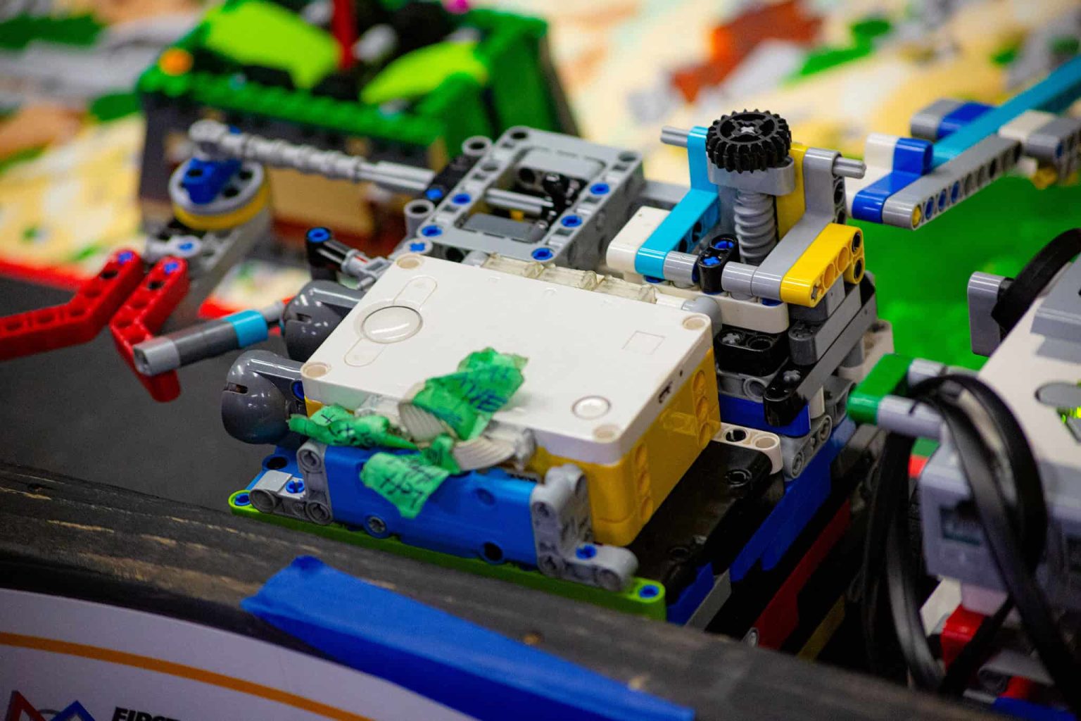 Close-up of a student-built robotics project with gears and electronic components.