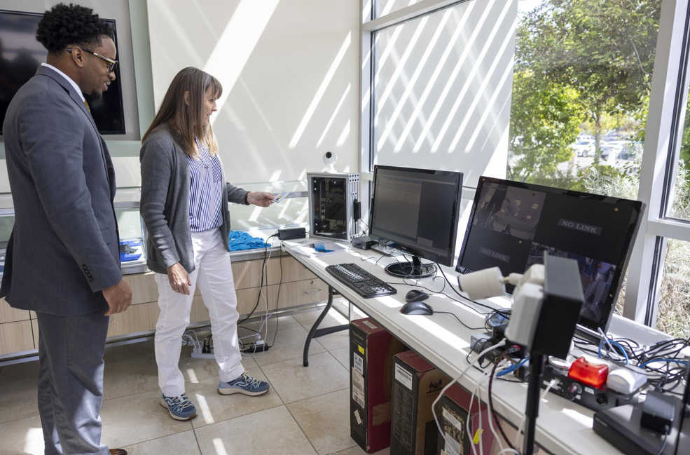 Two individuals looking at a computer screen