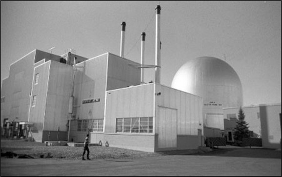 Black-and-white 1999 photograph of the MFC-768 facility, showing its industrial buildings, exhaust stacks and large domed structure.