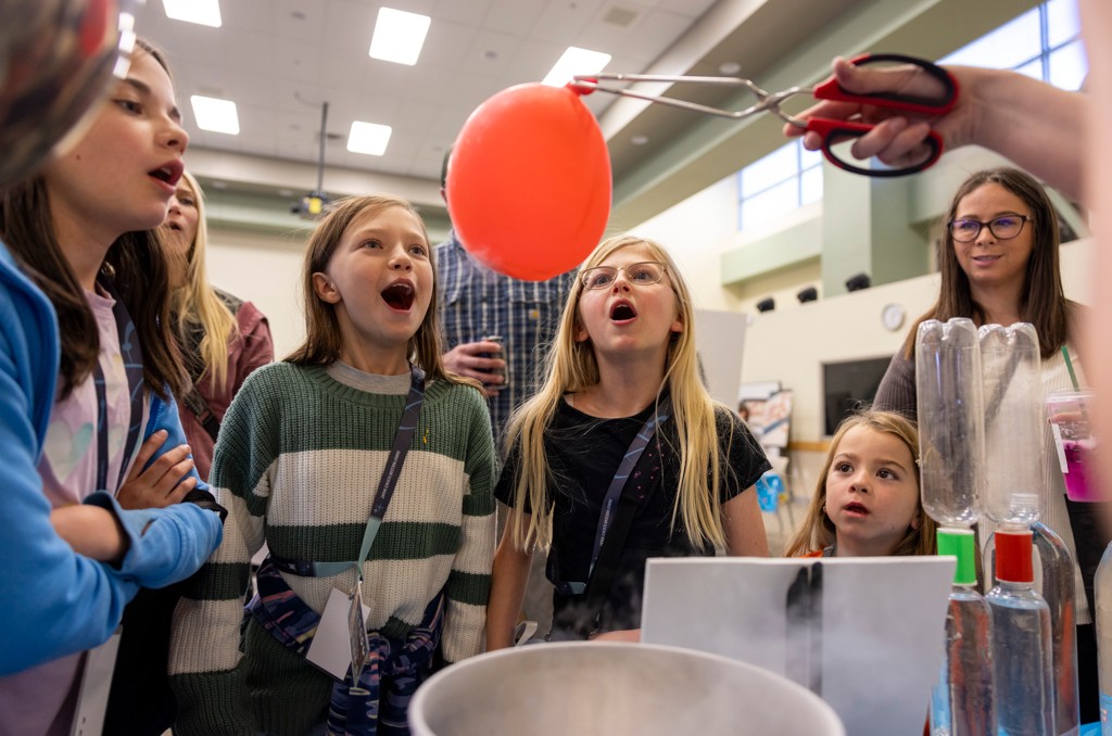 Students doing a science experiment at INL Family Nuclear Science Night. 