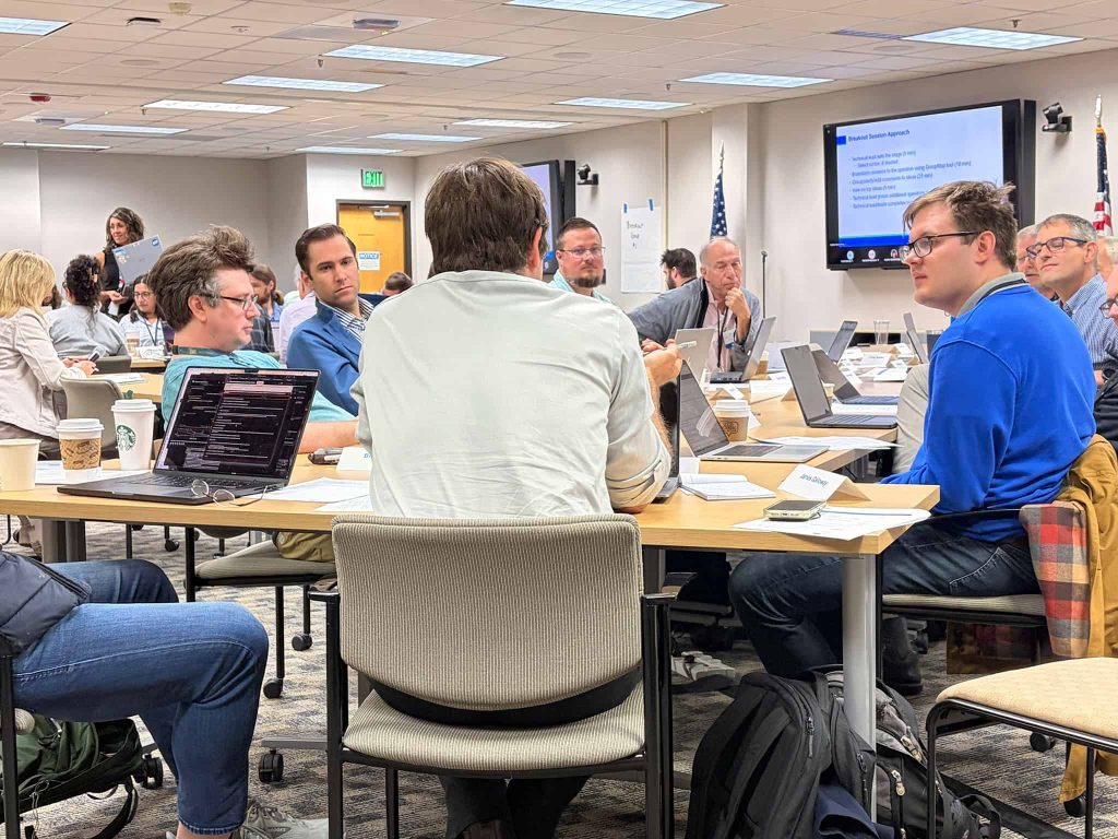 people sitting in groups conversing on a solution to a problem