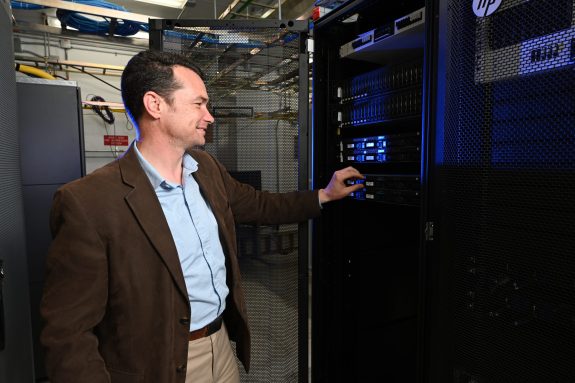 Sam Edwards checking the status of cellular servers at INL’s wireless test range.